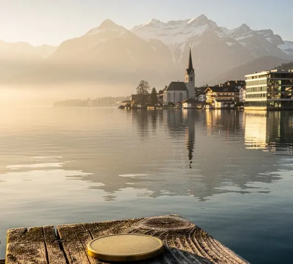 Vue panoramique du lac de Zoug avec reflets dorés symbolisant la convergence entre finance traditionnelle suisse et cryptomonnaies